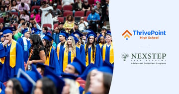 Students in blue cap and gowns at a graduation ceremony