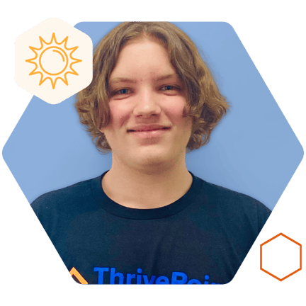 Student smiling and wearing a ThrivePoint shirt