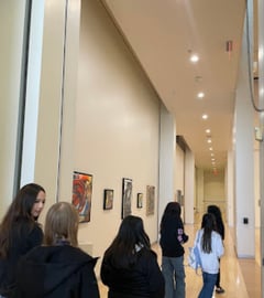 Students walking in a group looking at the art at the Yuma Art Center