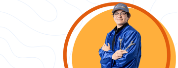 Student in a graduation gown holding tools