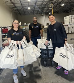 ThrivePoint staff holding all the tree care kits they assembled