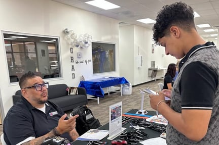 a student interacting with a representative from UT