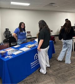 student talking to a community college representative